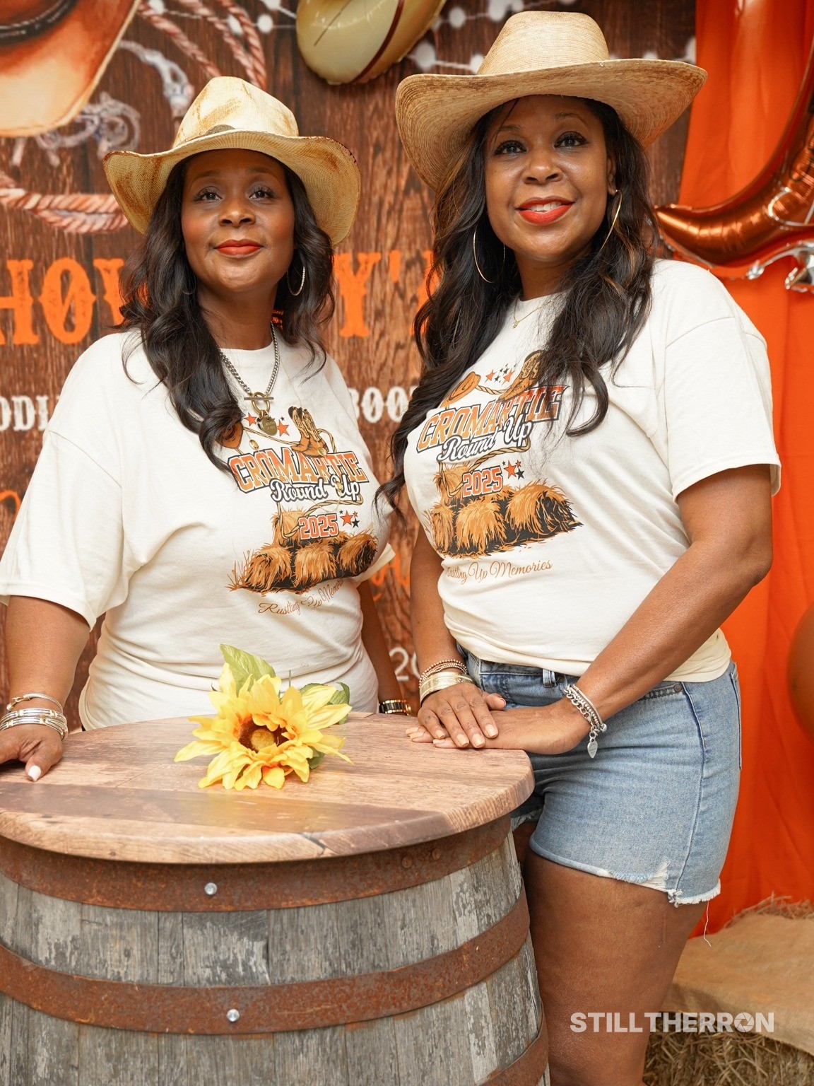 Women posing next to a barrel.